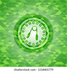 hand gripper icon inside green emblem. Mosaic background