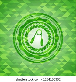hand gripper icon inside green emblem with mosaic background