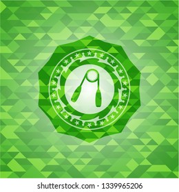 hand gripper icon inside green emblem with mosaic background
