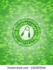 hand gripper icon inside green emblem with triangle mosaic background