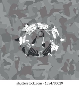 hand gripper icon inside grey camouflage texture