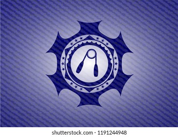 hand gripper icon inside jean or denim emblem or badge background
