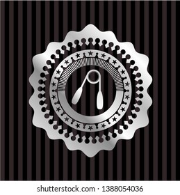 hand gripper icon inside silver emblem or badge