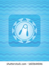 hand gripper icon inside sky blue water wave emblem background.
