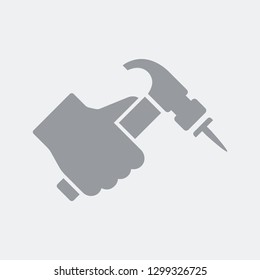 Hand hammering a nail symbol of the concept of work or restructuring