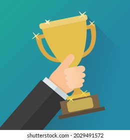 A hand held up a shiny golden cup as a sign of victory on a blue background (flat design)