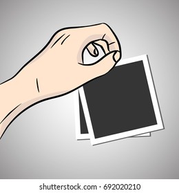 Hand hold blank photos. Vector photo frame with shadow.