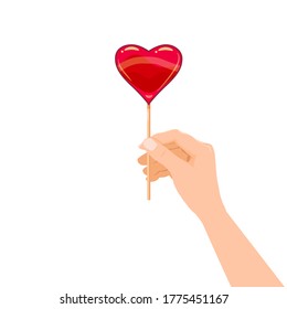 Mano sostiene la golosina de caramelo en forma de dulzura de postre cardíaco. Ilustración vectorial estilo de dibujos animados aislados