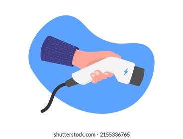 Hand Hold Electro Plug Connector On Blue Background. EV Charging Plug In Hand. Electric Car Concept.