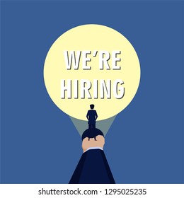 Hand hold flashlight and illuminate the text we are hiring.