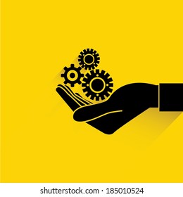 Hand Hold Gear On Yellow Background, Management Concept