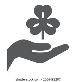Hand hold lucky clover glyph icon, st patrick's day and holiday, hand holding clover sign, vector graphics, a solid pattern on a white background, eps 10