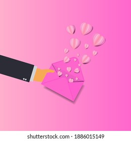 
Hand hold mail sending pink heart love valentine day concept.