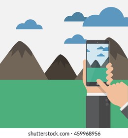 hand hold phone and capture memory on camera of a mountain view