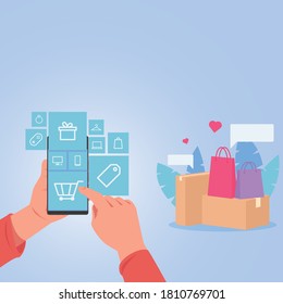 Hand hold phone tap on shopping icon for online shopping. Bags and box around.