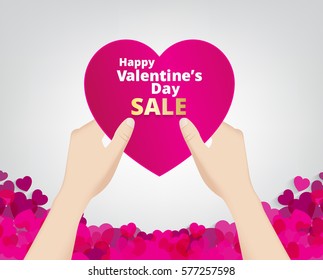 hand hold the pink heart label on heart footer background and sale text . Vector paper illustration.