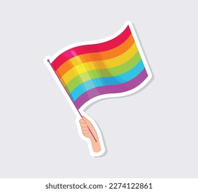 Hand hold rainbow LGBT flag, a symbol of the LGBT community.