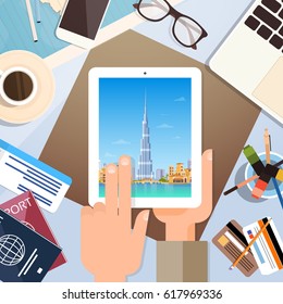 Hand Hold Tablet Computer With Dubai Skyline Panorama, Traveler Workplace With Passports Top Angle View Flat Vector Illustration