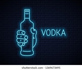 Hand hold vodka bottle neon sign. Male hand holding a vodka on wall background