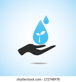 Hand hold water on tree sprout