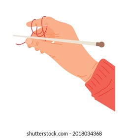 Hand holdigng knitting needle on white background