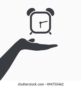 Hand holding alarm clock