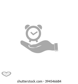 hand holding a alarm clock. Alarm icon . The clock shows the time