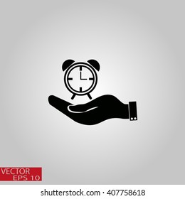 hand holding a alarm clock. Alarm icon . The clock shows the time
