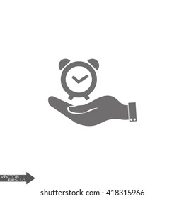 hand holding a alarm clock. Alarm icon . The clock shows the time