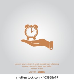 hand holding a alarm clock. The clock shows the time