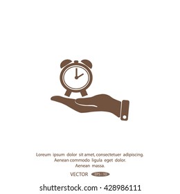 hand holding a alarm clock. The clock shows the time