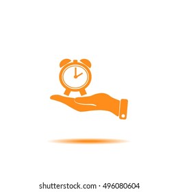 hand holding a alarm clock. The clock shows the time