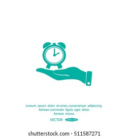 hand holding a alarm clock. The clock shows the time