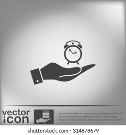 hand holding a alarm clock sign. Symbol morning. Alarm icon . The clock shows the time