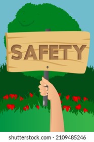 Hand holding up a banner with Safety text. Showing billboard banner, sign.