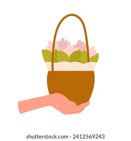 Hand holding a basket with flowers. Blooming spring pink flowers, gift bouquet cartoon vector illustration