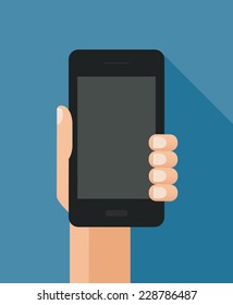 Hand holding black smart phone on blue background
