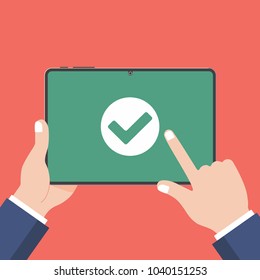 Hand holding black tablet device isolated on green background. Pad tablet on human's hands with check mark OK in the green circle and index finger pointer touch flat design vector illustration