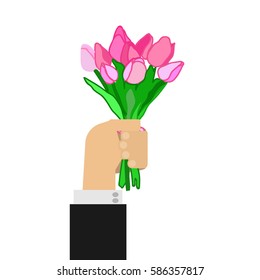 Hand holding bouquet of tulips