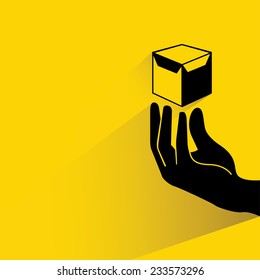 hand holding box on yellow background, flat and shadow theme