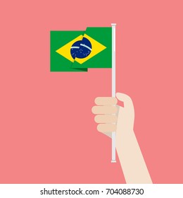 Hand Holding Up Brazil Flag. Vector illustration