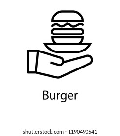 Hand holding bread with ketchup and sauces is burger 