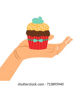 Hand holding brown and yellow chocolate cupcake gift, isolated vector illustration