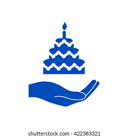 Hand holding a cake.
