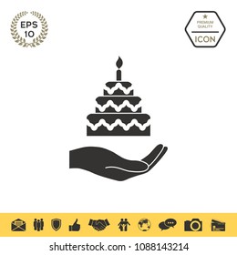 Hand holding a cake icon