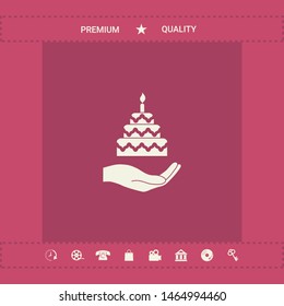 Hand holding a cake icon. Graphic elements for your design