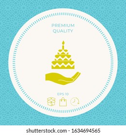 Hand holding a cake icon. Graphic elements for your design