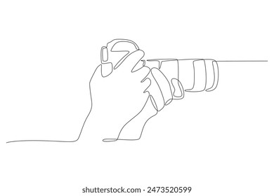 Hand holding camera. World photography day concept one-line drawing