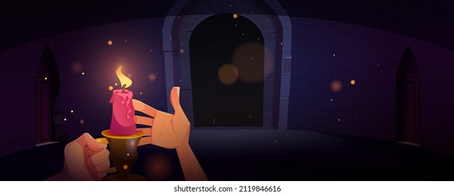 Hand holding candle in dark dungeon or medieval castle at night. Vector cartoon illustration of human hands with candlestick with burning fire in old room with stone walls and arch