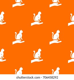 Hand holding a cat pattern repeat seamless in orange color for any design. Vector geometric illustration